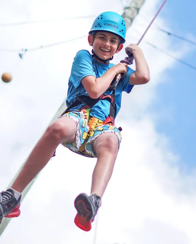 Summer camper on zip line